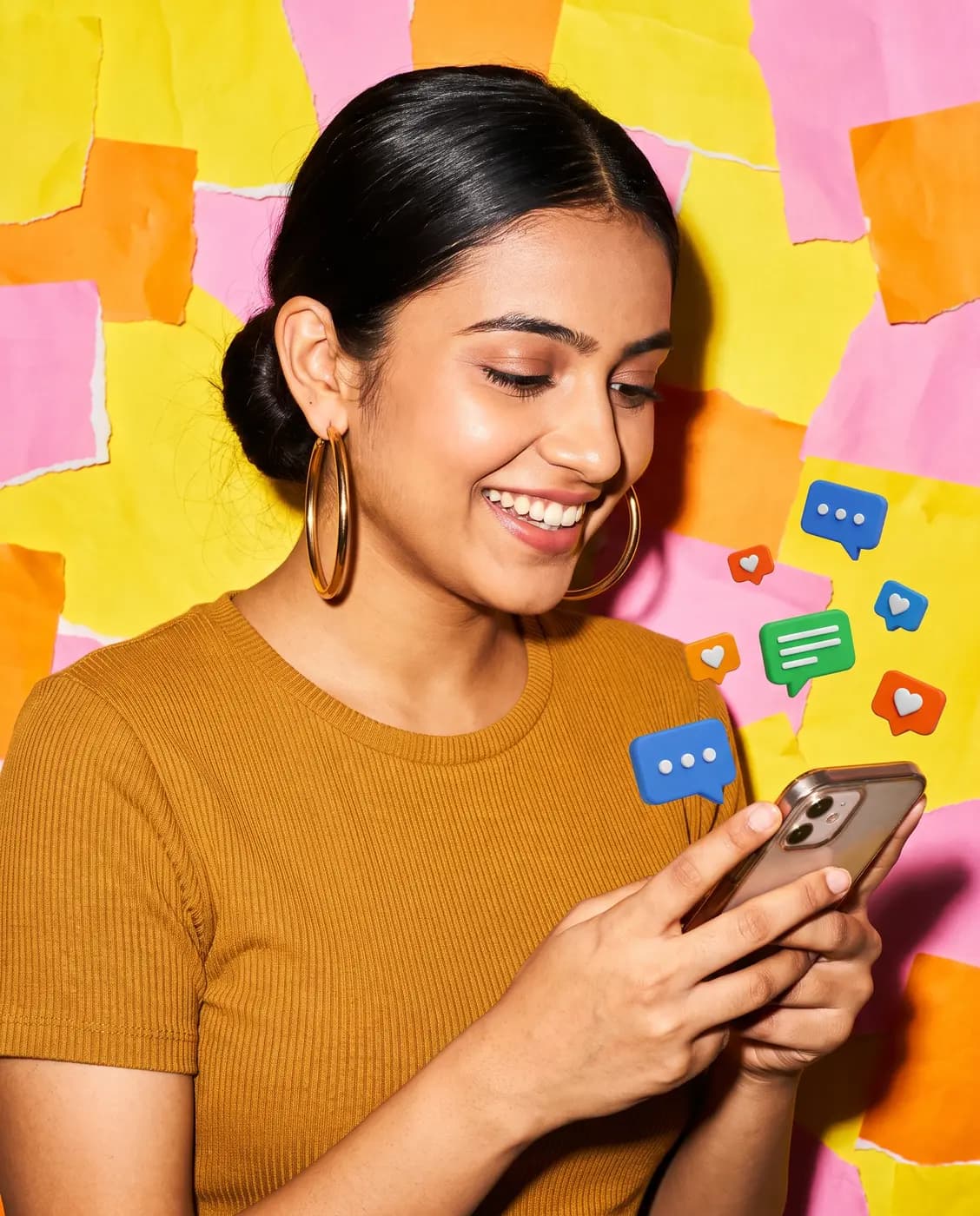 Young woman smiling at her phone with chat bubbles around