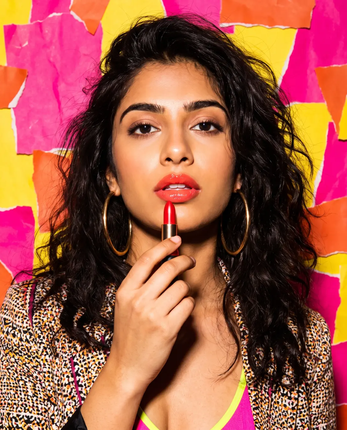 Model holding a red lipstick in a pink and yellow collage