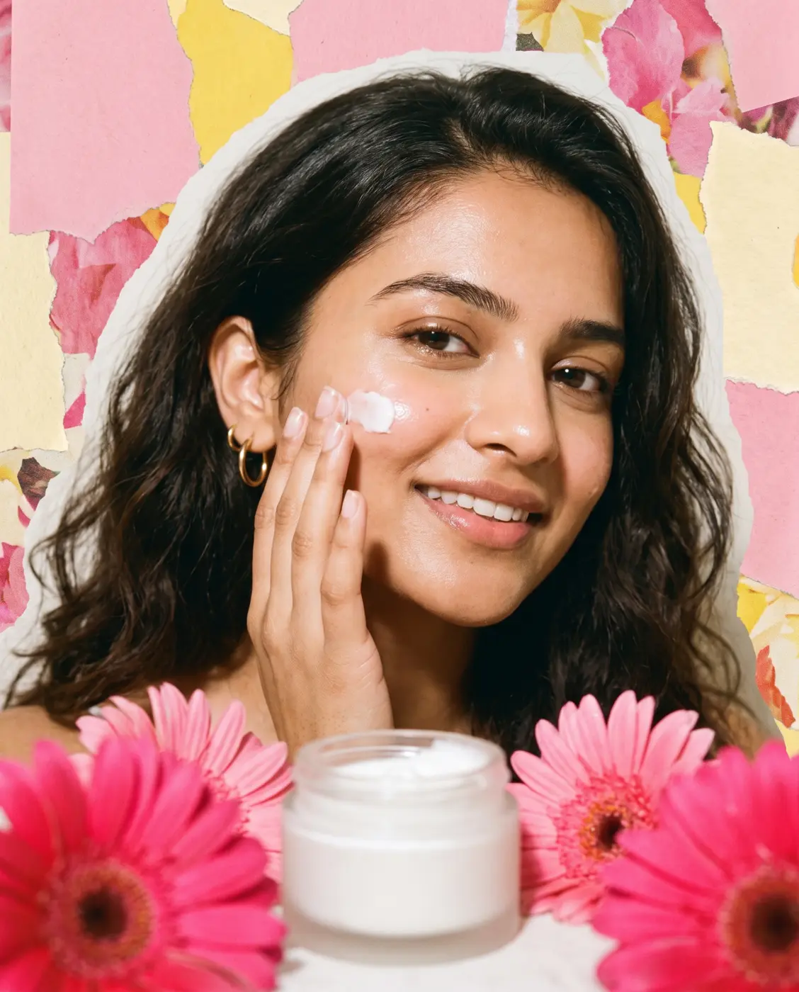 Model applying face cream with pink flowers and a cream jar