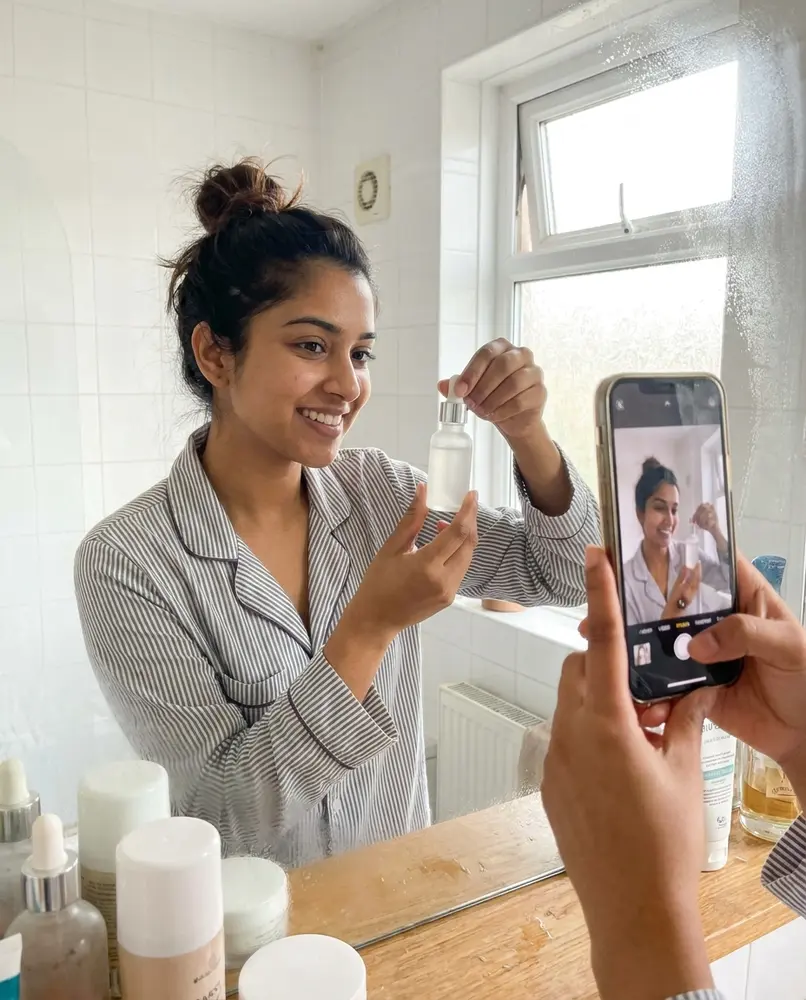 Creator filming her skincare routine in a mirror